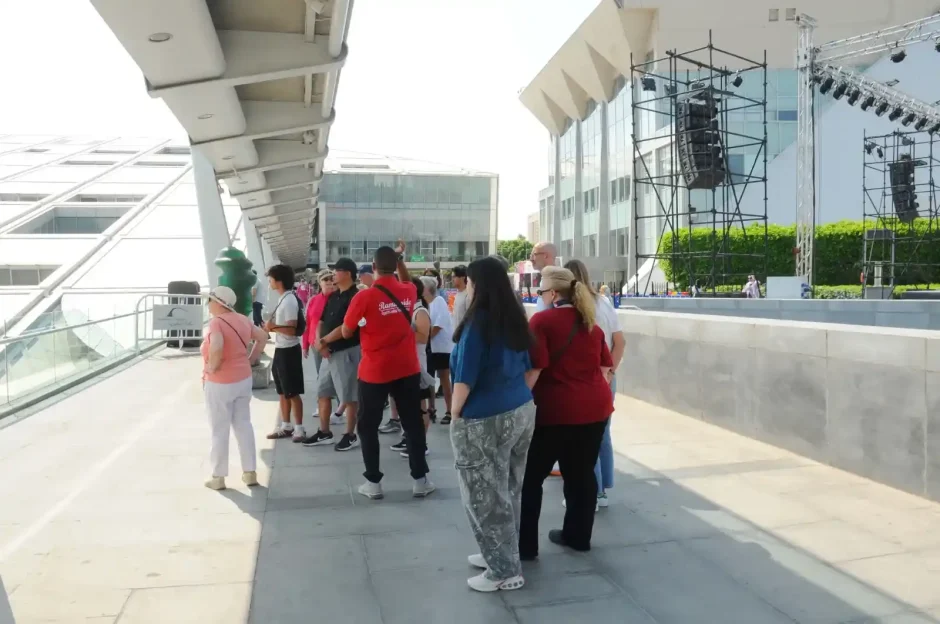 A group of tourists explores modern landmarks during a 4 Days Cairo & Alexandria Egypt Tour, enjoying the city's vibrant culture.