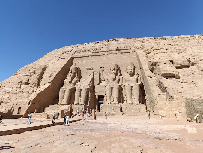 Tourists explore the massive rock-cut temples during an Aswan & Abu Simbel Tour, marveling at ancient Egyptian grandeur.