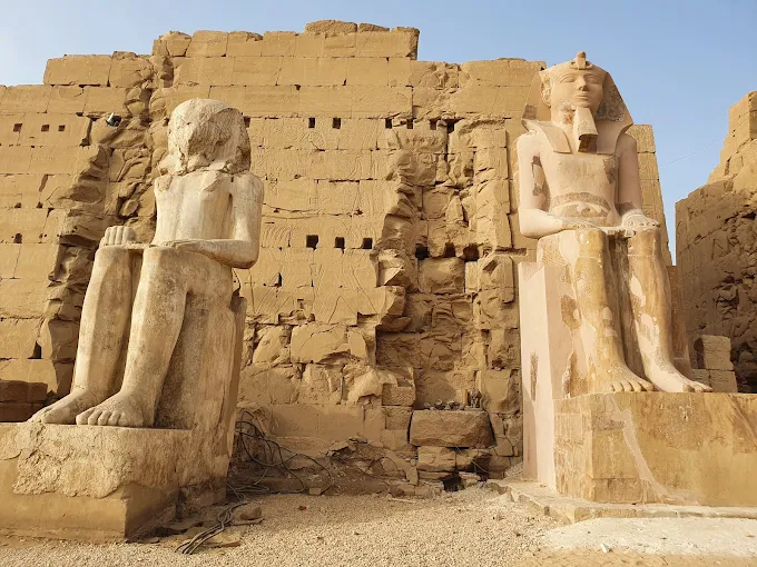 Ancient statues at Luxor, The Open-Air Museum, showcase Egypt's rich history near the Nile River.