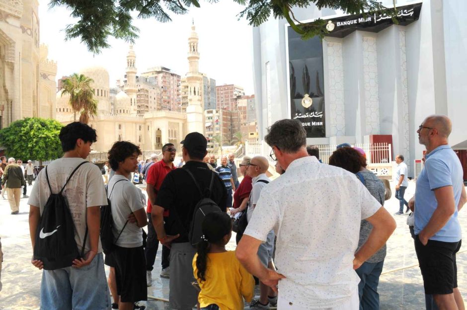 Visitors gathering in the historic square near the Abu al-Abbas al-Mursi Mosque to admire the intricate Islamic minarets and domes.