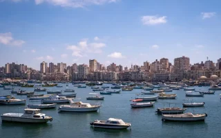 A professional private tour guide explaining Roman history to a group of tourists during a day trip from Cairo to Alexandria.