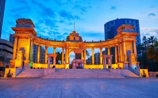 The Unknown Soldier Memorial in Alexandria at dusk, featuring illuminated Roman-style