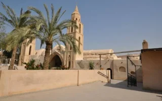 The ancient stone architecture and bell tower of a Coptic monastery in Wadi El-Natrun, Egypt, visited during a day trip from Alexandria.