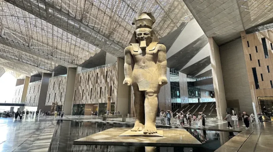 Grand Ramses II statue standing in the Grand Egyptian Museum atrium, showcasing ancient Egyptian heritage to modern visitors.
