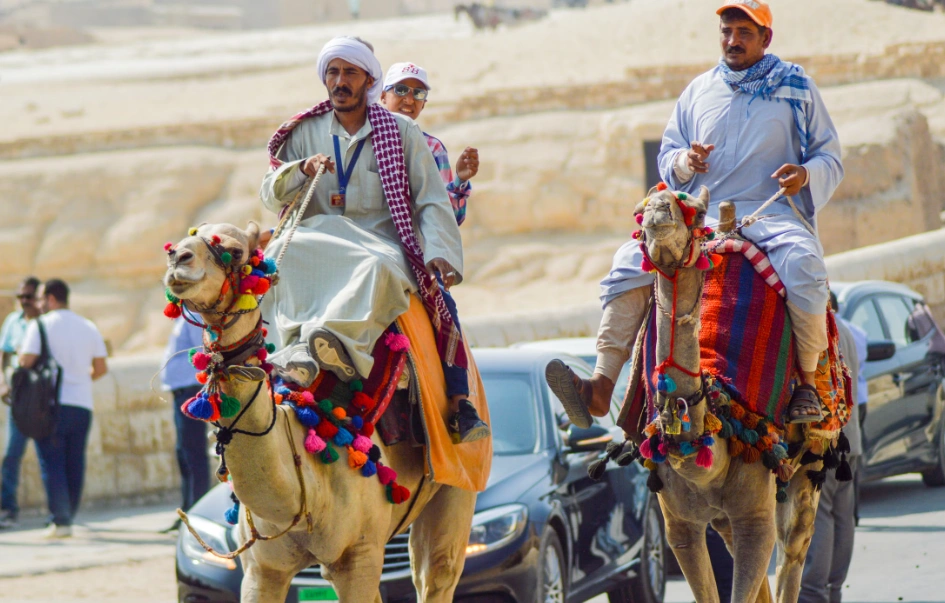 Local guides riding camels near the Pyramids of Giza